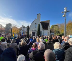 large gathering of people in front of war memorial