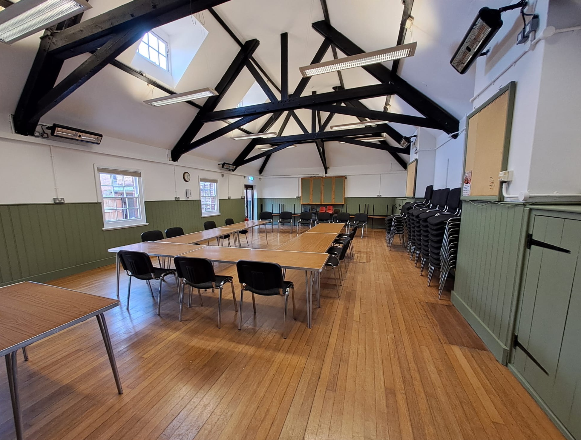 community hall with chairs and table, and  ceiling beams