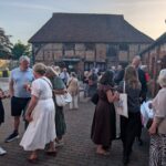 Group of people talking people at an outdoors drinks reception
