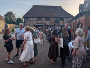 Group of people talking people at an outdoors drinks reception