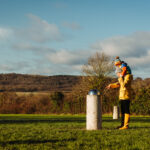 parent and child wearing winter clothes in a field