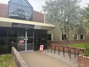 exterior of leisure centre building with ice cream sign in front
