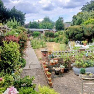 garden with flowers and white outdoor table and chairs