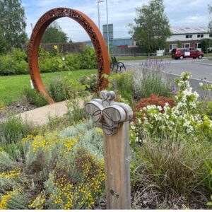 garden with world war remembrance arch and wooden butterfly